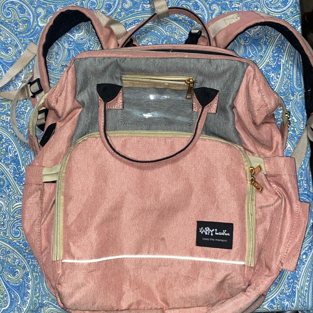 Used like new Happy Luoka changing table diaper bag. Pink.